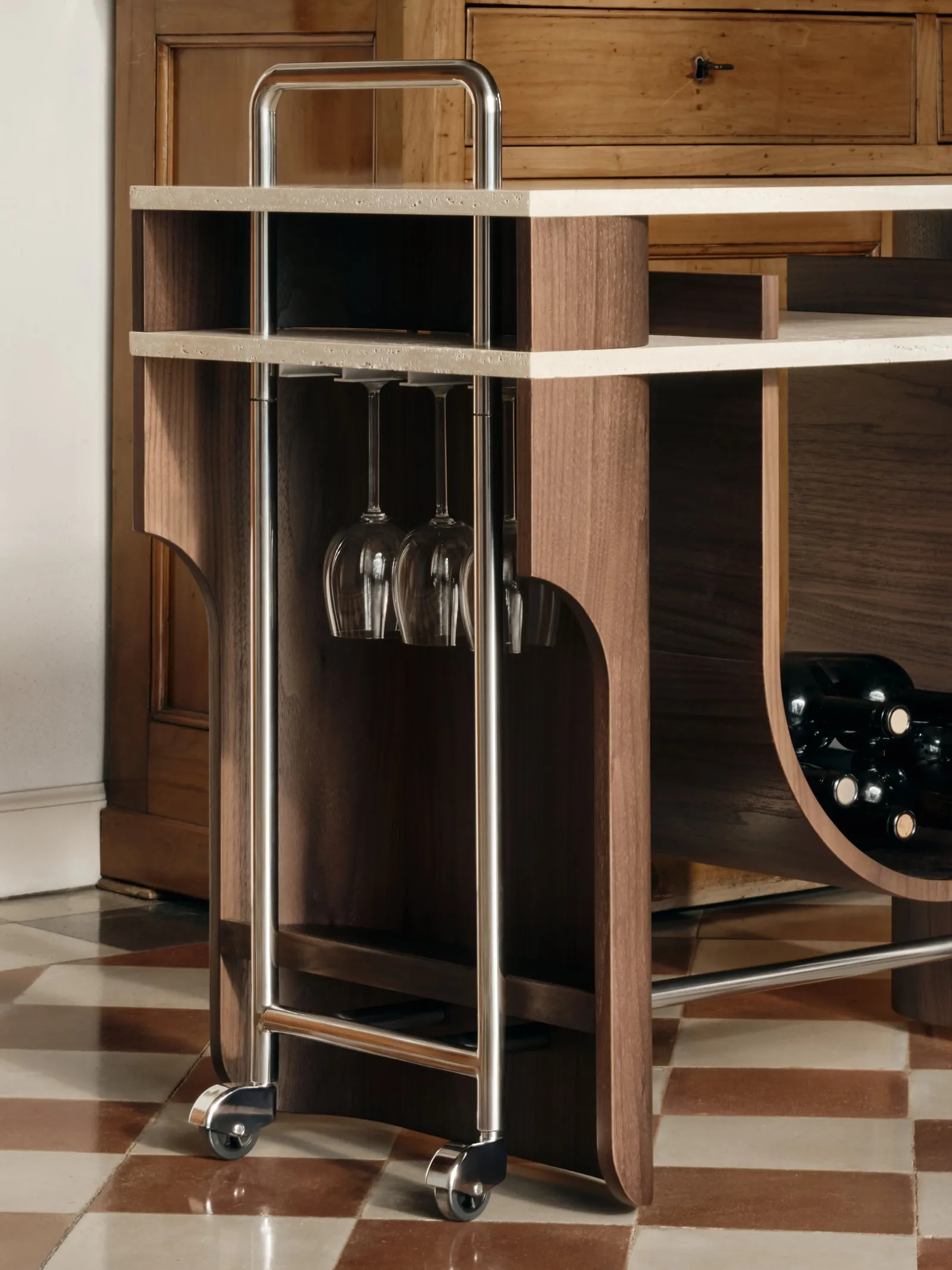 Close view of the Arcus Bar Cart steel handle, glass rack and wheels