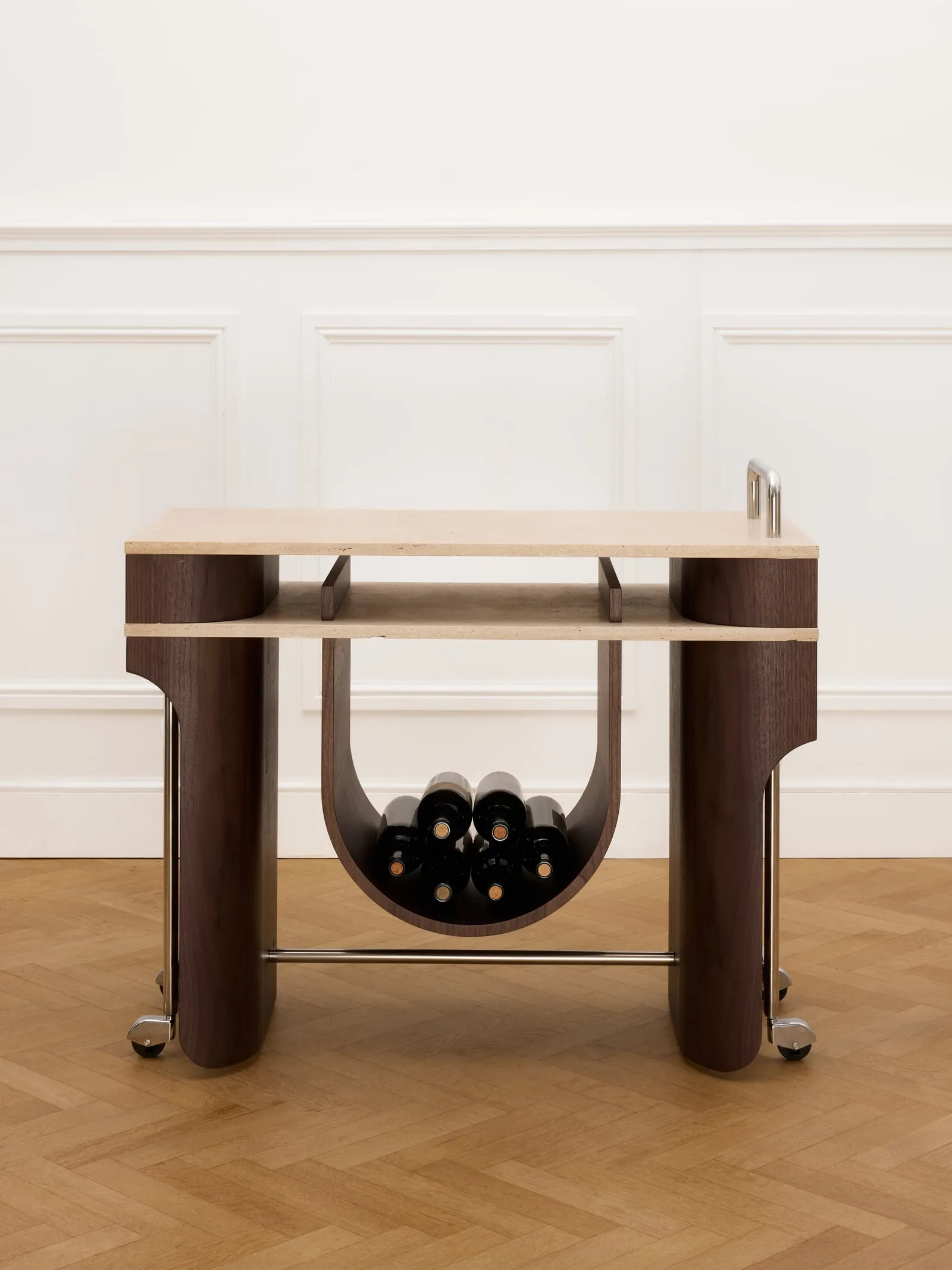Arcus Bar Cart from the front, with wine bottles in its curved cradle