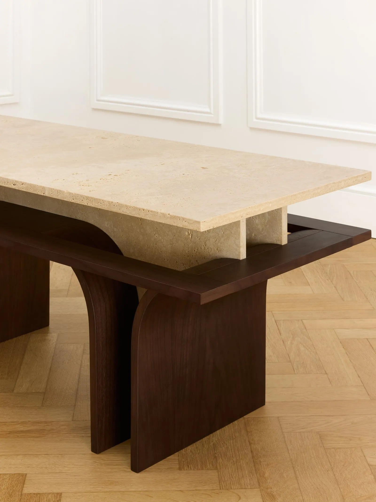 Arcus Bench close up from above, showing the travertine top meeting the wooden apron