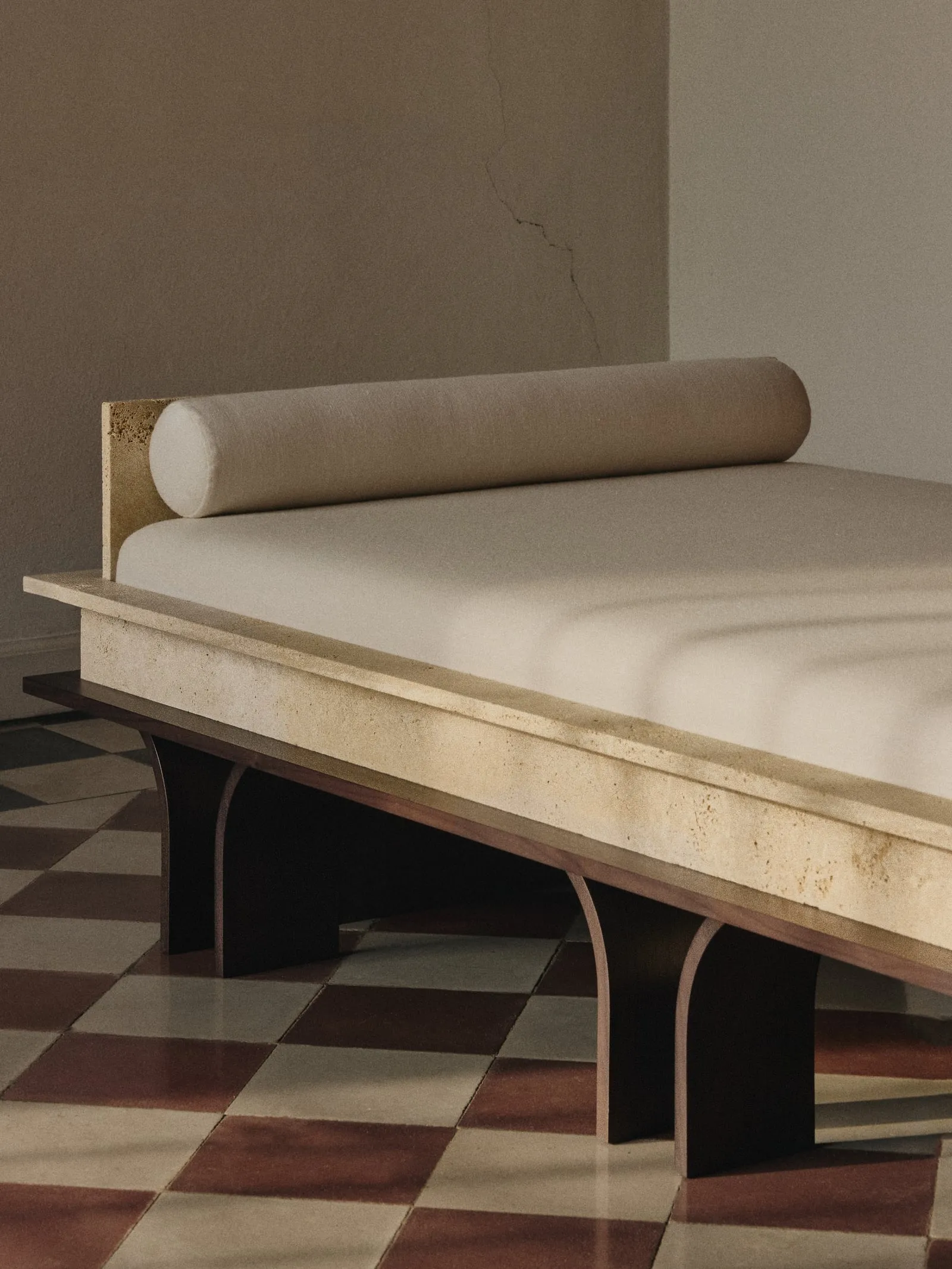 Arcus Daybed close up, showing the upholstered cushion, bolster and arched wooden base