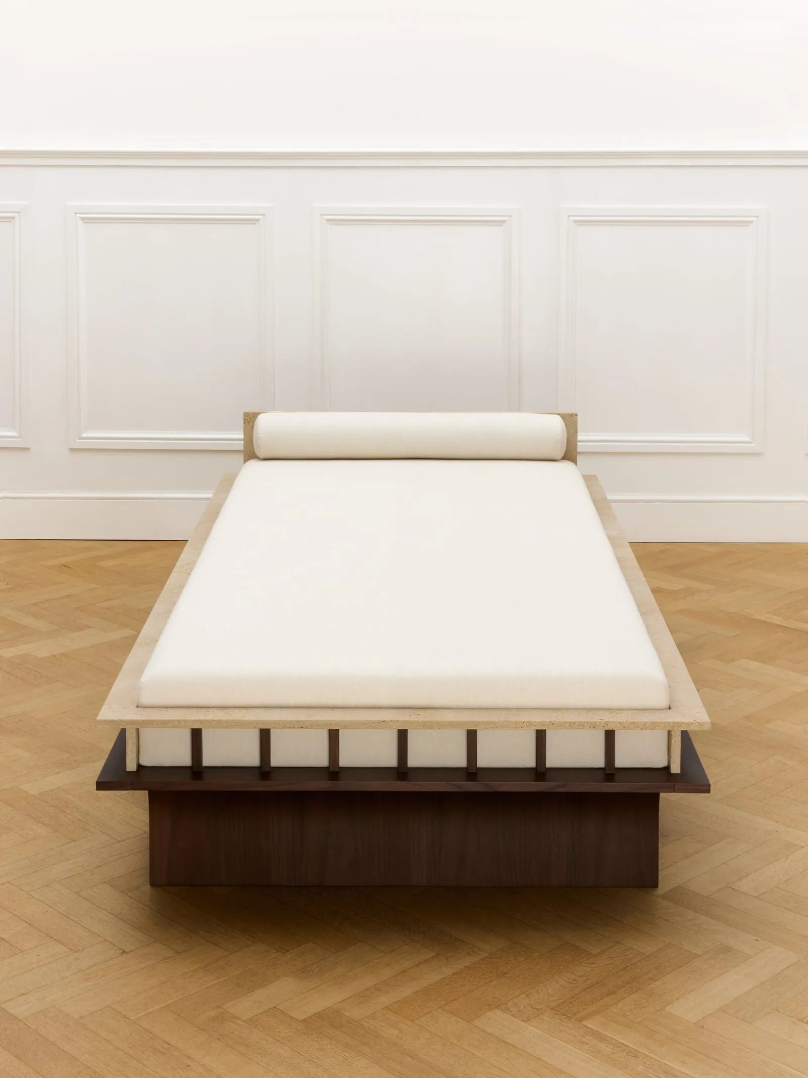 Arcus Daybed seen end-on, with its bolster cushion at the head